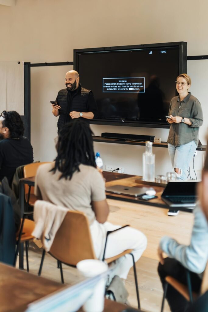 A group of adults attending a business presentation in a contemporary office space.